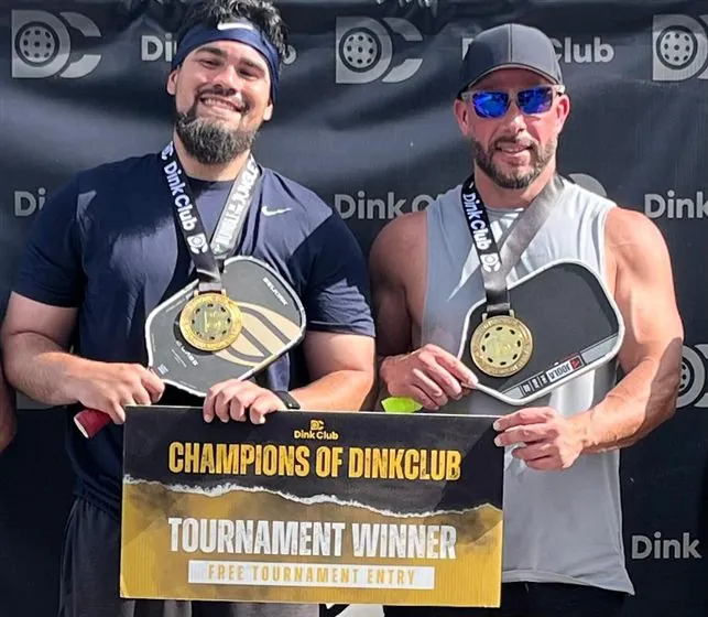 Tournament champions holding medals and paddles at Dink Club