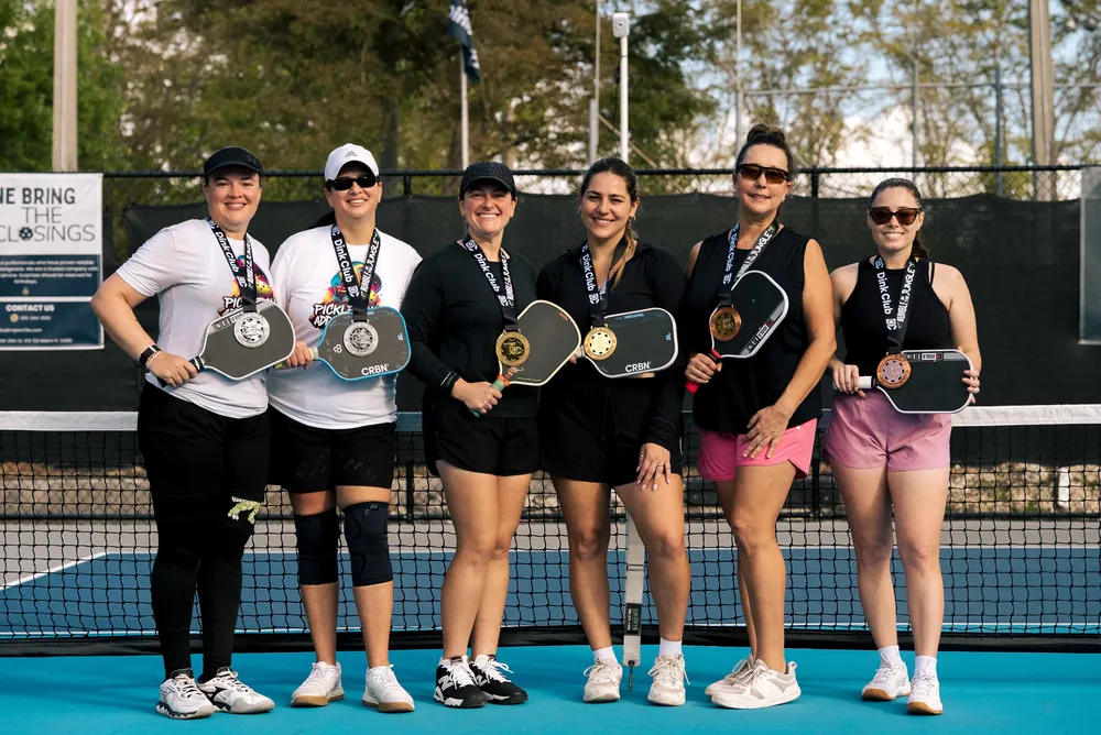 Women's champions group at a Dink Club pickleball tournament in Miami