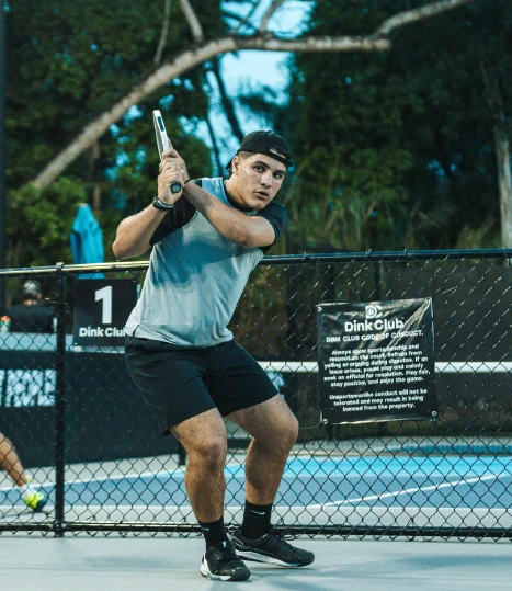 Pickleball player mid-swing on the courts at Dink Club in Miami